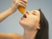 Γυμνός έφηβος πίνει χυμό πορτοκαλιού